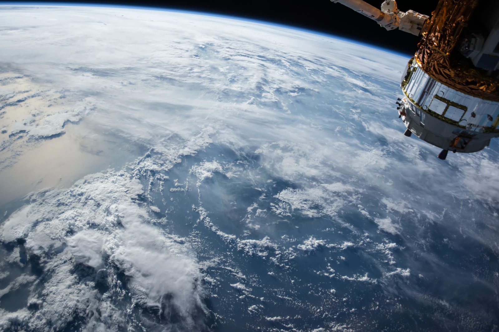Earth seen from orbit, satellite hardware in frame